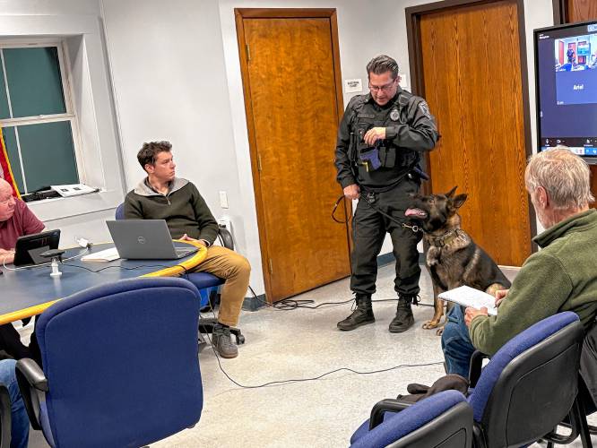 Montague Police Officer James Ruddock introduces the Selectboard to the Police Department’s new K-9, Lawrence “Larry” Akim, on Monday.