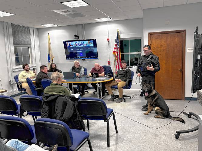 Montague Police Officer James Ruddock introduces the Selectboard to the Police Department’s new K-9, Lawrence “Larry” Akim, on Monday.