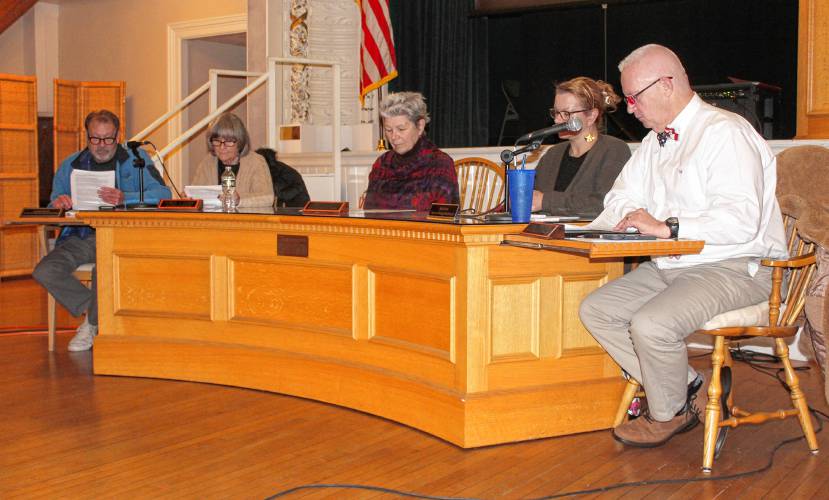 From left, Orange Selectboard Clerk Andrew Smith, Vice Chair Pat Lussier, member Jane Peirce, Julie Davis and Chair Tom Smith sit at the front of Orange Town Hall’s Ruth B. Smith Auditorium during a Special Town Meeting on Monday.