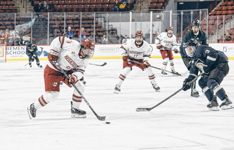 UMass’ Jack Musa (9) carries the puck against Army during action last week at the Mullins Center.