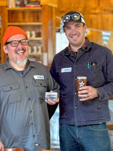 Chris Hooper and Chris Sellers, of The Brewery at Four Star Farms in Northfield, with a Franklin County Gift Card. The brewery is among a growing number of participating businesses.