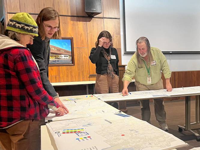 Alex Garbier, a senior engineering associate with Kittelson & Associates Inc., second from left, explains data to an attendee of a public input session on Wednesday at the John W. Olver Transit Center in Greenfield. The public feedback will be used to help develop a Road Safety Action Plan.