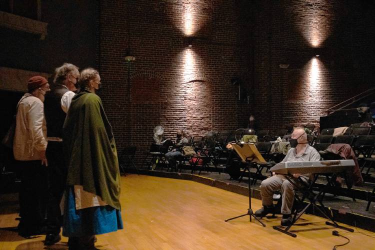 Performers, under the direction of Greenfield resident Fred Momaney, right, rehearse for their production of “Welcome Yule: A Midwinter Celebration” at the Shea Theater Arts Center in Turners Falls.