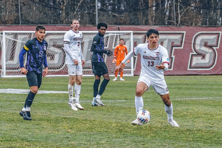 UMass junior Joseph Bianco (13), of Belchertown, dribbles the ball up the field during the Minutemen’s 2-1 win over Evansville in the first round of the NCAA Tournament at Rudd Field in Amherst on Nov. 21.