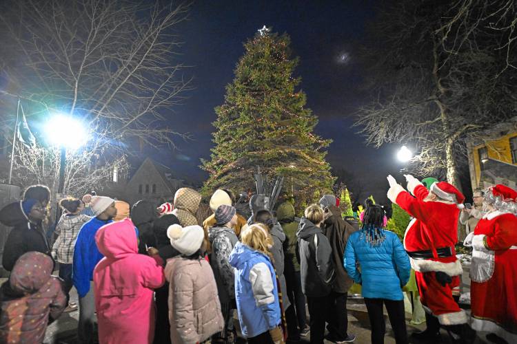 Santa helps light the Christmas tree at Veterans Mall during the first night of Jingle Fest in Greenfield on Friday night.