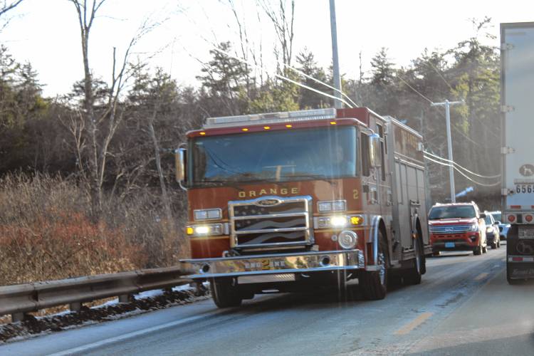 An Orange fire truck near the scene of a three-vehicle crash on Route 202 in New Salem on Friday.