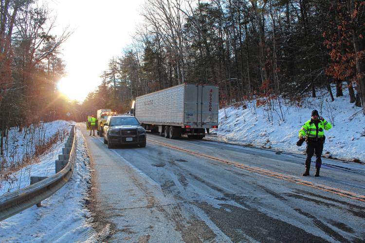 Authorities work at the scene of a three-vehicle crash on Route 202 in New Salem on Friday.