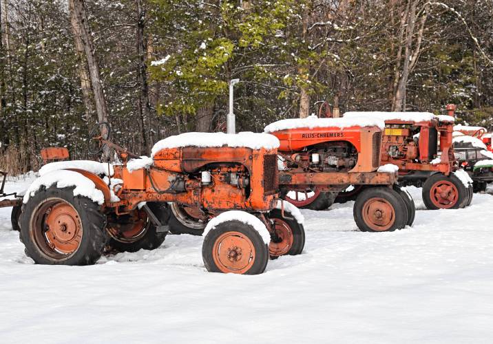 Three tractors are frosted with fresh snow on Barton Road in Greenfield.