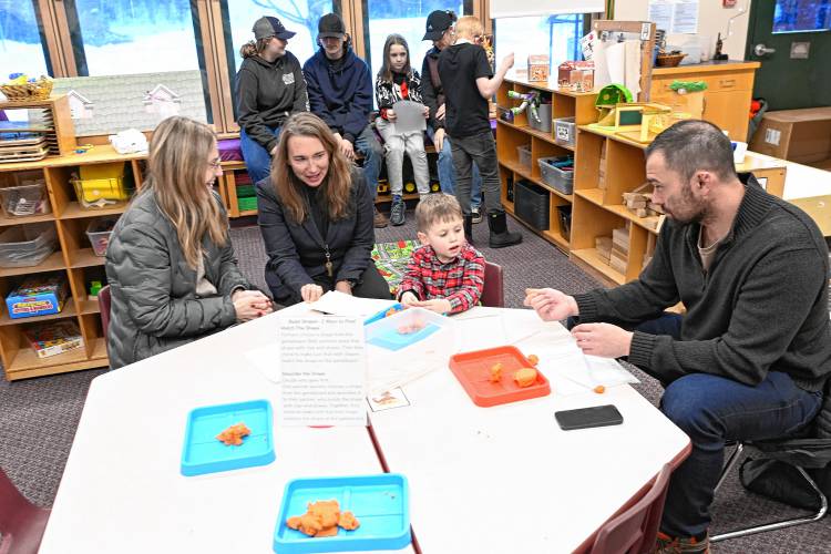 From left, Brett Walker talks with Superintendent Carole Learned-Miller next to her son Forest Walker and husband Ray Walker at Warwick Community School’s Community Exhibition of Learning on Friday afternoon.