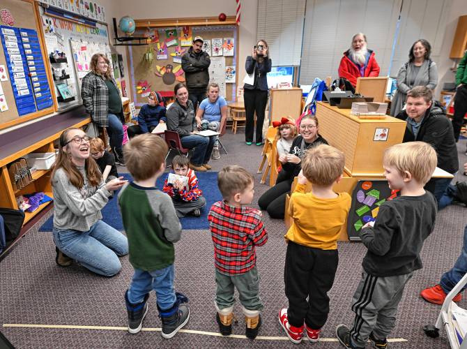 Christina Tomasik, left, leads her junior kindergarten students in song at Warwick Community School’s Community Exhibition of Learning on Friday afternoon.