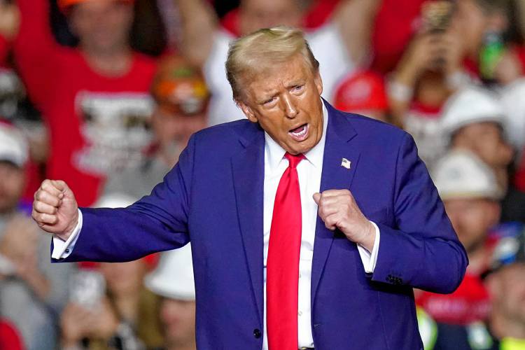 Republican presidential nominee former President Donald Trump dances after speaking at a campaign rally at PPG Paints Arena, Monday, Nov. 4, 2024, in Pittsburgh.