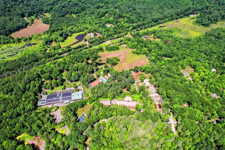 The sprawling Leverett estate built by late Yankee Candle Co. founder Michael J. Kittredge II. The site is bounded by Amherst Road to the east, railroad tracks to the west, and Juggler Meadow Road to the north, and extends into Amherst to the south.