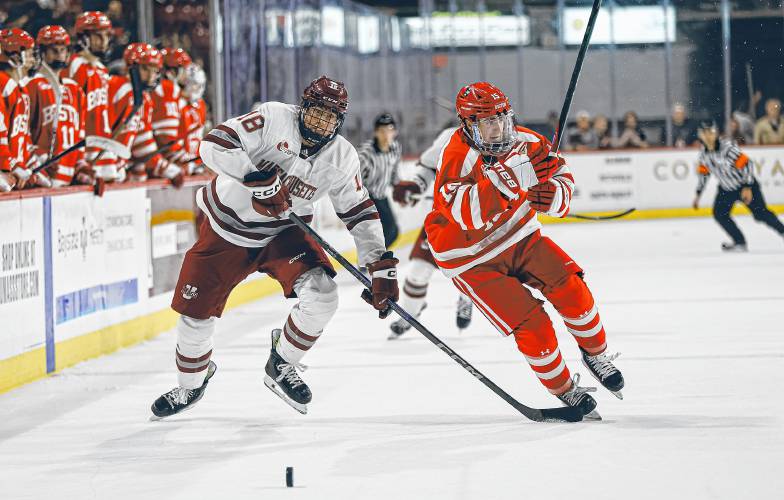 UMass’ Larry Keenan (18), left, and Boston University’s Matt Copponi (15) battle for a loose puck during the Minutemen’s 4-2 loss at the Mullins Center on Wednesday night in Amherst.