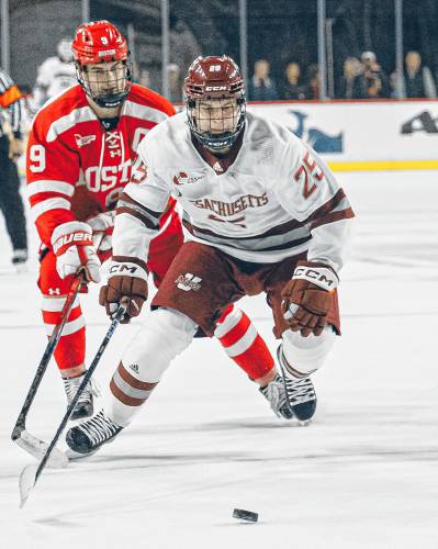 UMass’ Daniel Jencko (25) chases after a loose puck during the Minutemen’s 4-2 loss to Boston University on Wednesday night at the Mullins Center in Amherst.