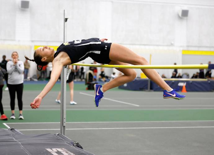 Pioneer’s Louise Flagollet clears a second place jump in girls high jump Thursday at Smith College.