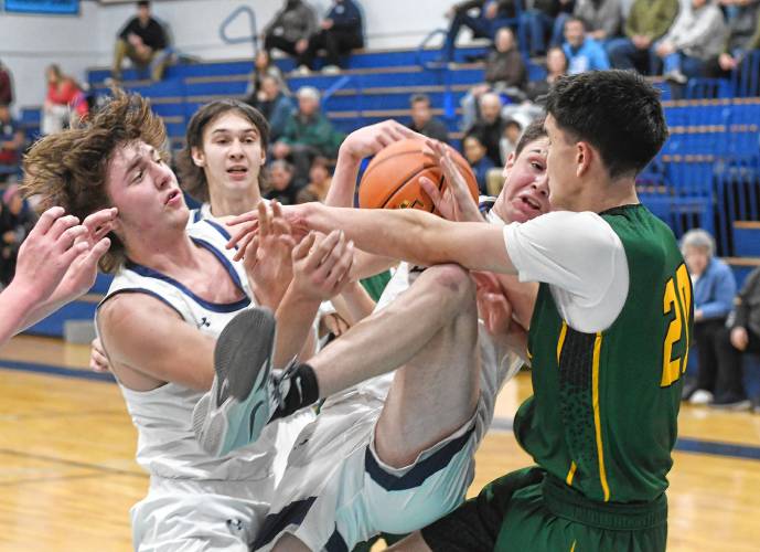 Franklin Tech’s Brody Hicks comes down with a rebound against Saint Mary’s during the Eagle Holiday Classic in Turners Falls on Thursday.  At left is Tech’s Nolyn Stafford with Gabe Mota at rear.