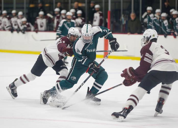 Greenfield’s Jake Jurek (2) maneuvers the puck between the Amherst defense during action last season at Orr Rink in Amherst. Jurek and the Green Wave open their 2024-25 campaign Saturday at Southwick.