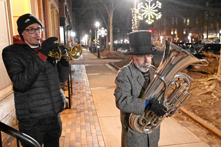 Jason Mosall on trumpet and Kevin Smith on tuba play holiday music on Avenue A as part of “It’s a Wonderful Night in Turners Falls” on Friday.